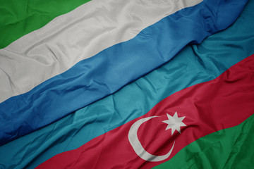 waving colorful flag of azerbaijan and national flag of sierra leone.