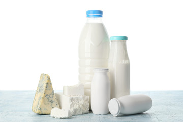 Different dairy products on table against white background