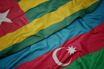 waving colorful flag of azerbaijan and national flag of togo.