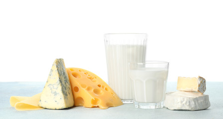 Different dairy products on table against white background