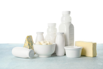 Different dairy products on table against white background