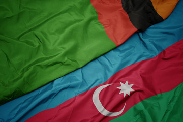 waving colorful flag of azerbaijan and national flag of zambia.