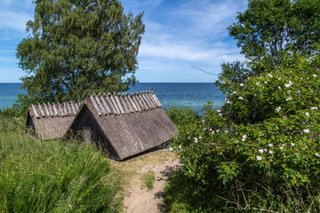 Fototapeta na wymiar View of Knäbäckshusens Chapel on a sunny summer day with the blue waters of the Baltic Sea in the background.