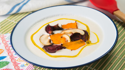 Creamy cauliflower soup with with dried apple, pumpkin and beet.