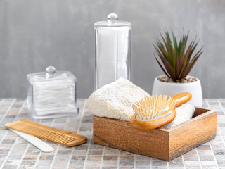 Hygienic bathroom and spa accessories. Cotton pads and buds, wooden hair brush, towel. Body and hair care at home.