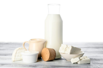 Different dairy products on table against white background