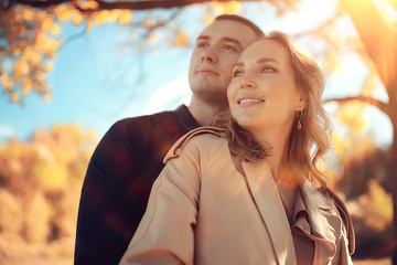 lovers in autumn sunny park, landscape people on a walk in Indian summer