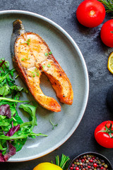 pink salmon steak fried and salad,
grilled seafood, pescatarian Menu concept food background keto or paleo diet. top view. copy space for text