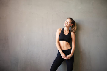 young woman doing exercise on yellow background
