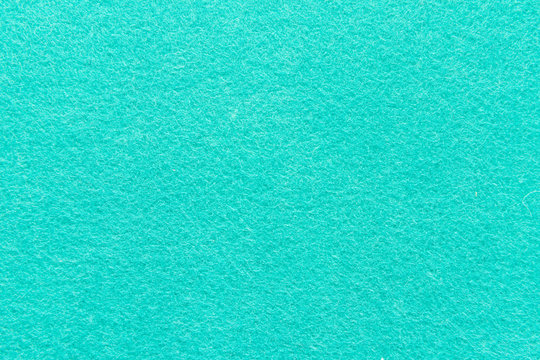 High resolution close up of bright cyane felt fabric texture of rough fleecy fabric of blue color for backgrounds and for wallpaper an intense cyane piece of textured felt fabric with rough touch.