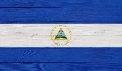 Nicaragua flag on a wooden texture. Wood texture, planks Wooden texture background flag. Flag painted with paints on wood