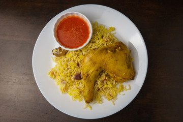 arabic chicken mandi rice on wooden dine table. top view