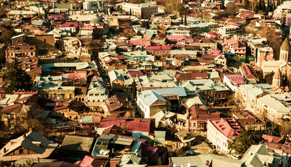 Panorama of the city of Tbilisi from a high point. Tiled roofs of old houses. View of the old city.