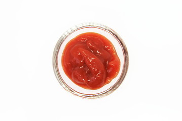 ketchup in a saucer on a white background