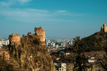 Naklejka premium Panorama of the city of Tbilisi from a high point. Tiled roofs of old houses. View of the old city.