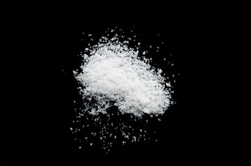 Obraz na płótnie Canvas salt on a black background,salt on wooden spoon isolated on white background,A pile of coarse salt on a black background