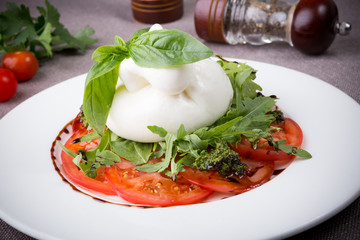 Buffalo burrata cheese served with fresh raw tomatoes