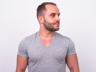Fototapeta premium Portrait of muscular bearded man thinking and looking away