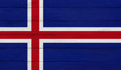 Fototapeta premium Iceland flag on a wooden texture. Wood texture, planks Wooden texture background flag. Flag painted with paints on wood