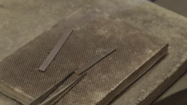 goldsmith soldering pieces of gold