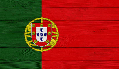 Fototapeta premium Portugal flag on a wooden texture. Wood texture, planks Wooden texture background flag. Flag painted with paints on wood