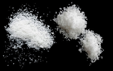  salt on a black background,salt on wooden spoon isolated on white background,A pile of coarse salt on a black background