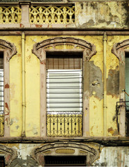 Fototapeta na wymiar Dilapidated Revival house in the city of Melilla. Spain. Detail of balcony. 