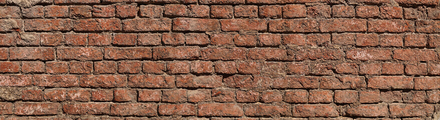 Obraz premium Old brick wall destroyed by time. Panorama of the building walls.