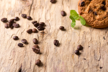  coffee beans sprinkled on a wooden board