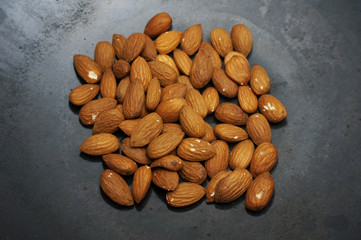 Roast almond peanut on a black skillet.         