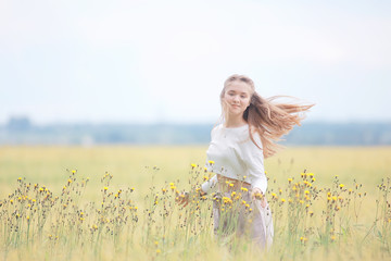 blonde with long hair in autumn field / concept of happiness health young adult model in summer landscape