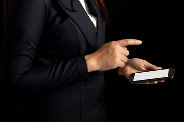 Professional business woman using smartphone blank screen on black background