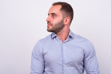 Fototapeta premium Profile view of bearded businessman looking away