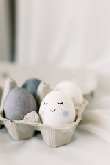 Easter eggs in an egg box on a white background