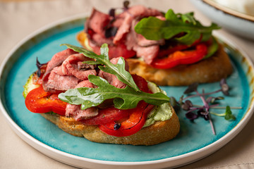 Assorted bruschetta with various toppings. Appetizing bruschetta or crudo crostini. Variety of small sandwiches. Mix bruschetta