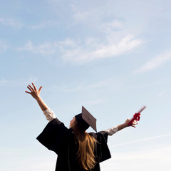 Low angle young woman celebrating her graduation