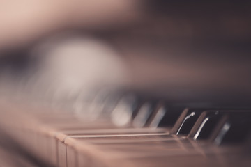 Old vintage piano closeup with focus on keys.