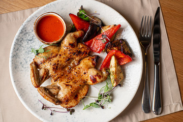 Chicken with potato garnish on wooden spilah.Rustik still life.