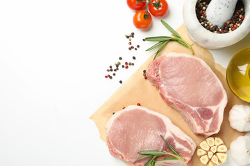 Composition with raw meat and ingredients on white background, top view
