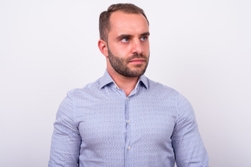 Fototapeta premium Portrait of bearded businessman thinking and looking up
