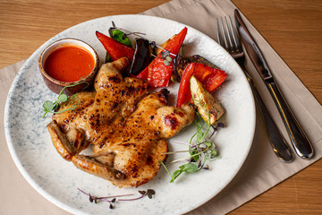 Chicken with potato garnish on wooden spilah.Rustik still life.