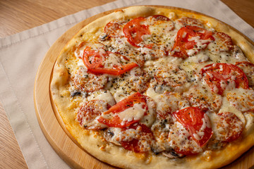 Pizza pepperoni, mozzarella, oregano on a black background