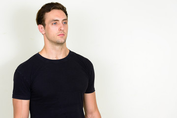 Fototapeta premium Portrait of young handsome man thinking and looking up