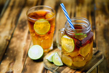 iced tea cocktail with strong drinks, wood background