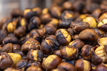 Roasted sweet chestnuts closeup, street food market