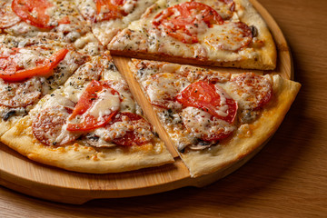 Pizza pepperoni, mozzarella, oregano on a black background