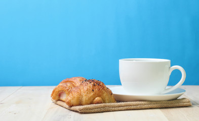 Croissant and coffee   on wood table