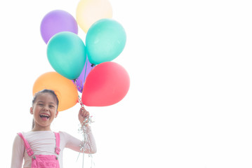 Fototapeta na wymiar happy little asian girl child playing with colorful toy balloons outdoors. summer holidays, celebration, family, children and people-happy girl with colorful balloons. freedom and imagination concept.