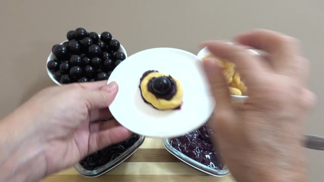 Table prepared with freshly harvested jaboticaba or jaboticaba jam. Donut biscuits to accompany. Organic red Brazilian fruit rich in vitamins.