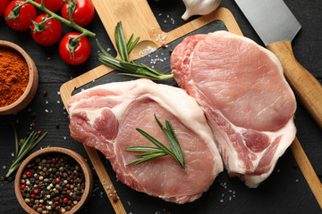Composition with raw meat for steak and ingredients on wooden background